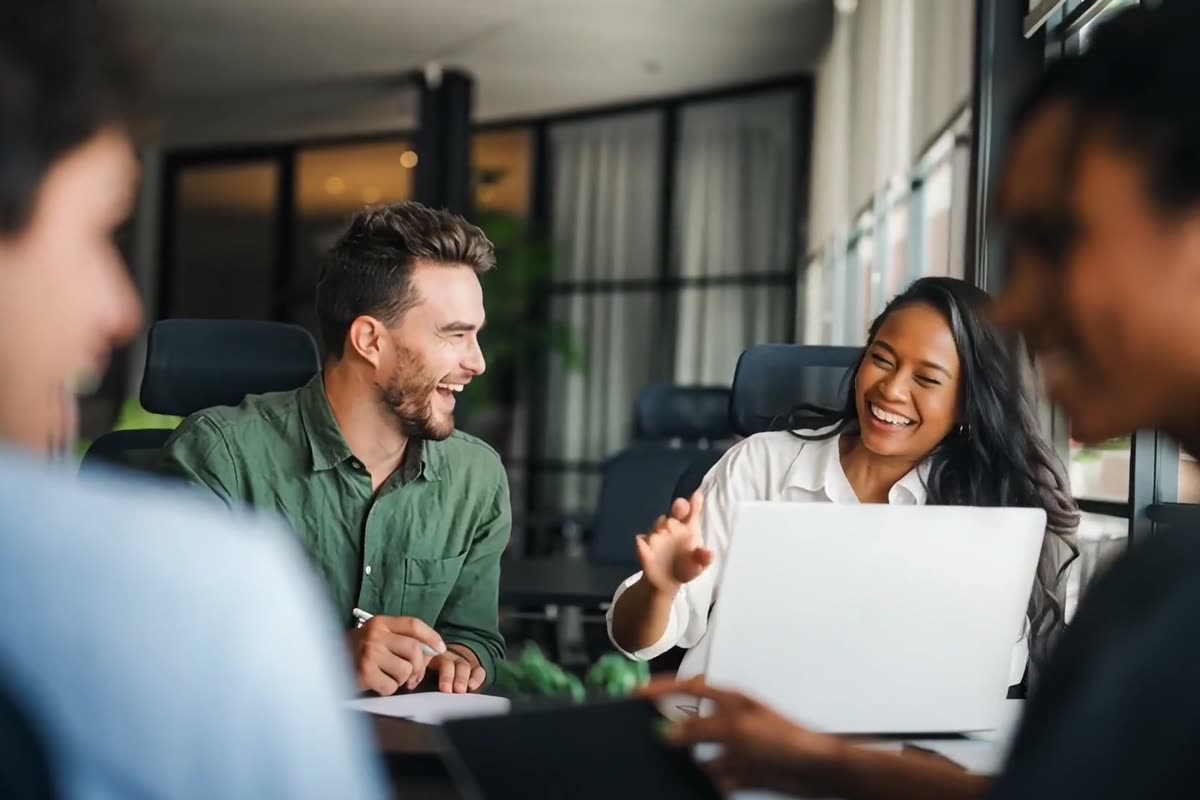 Colleagues working together at a desk in an office
